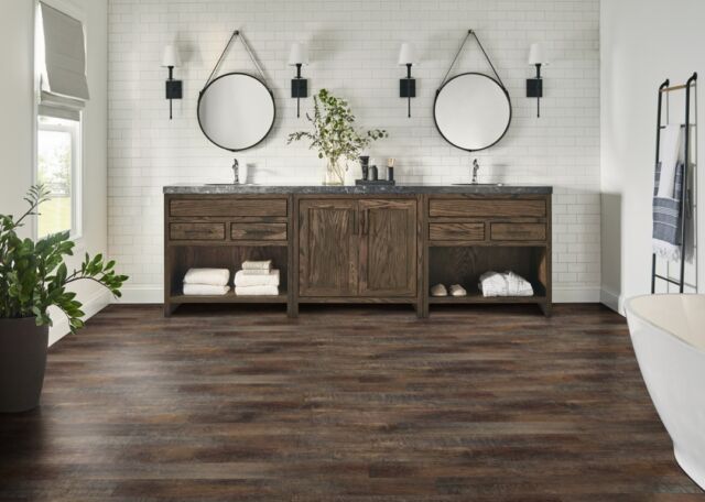 Transform your morning routine from “Do I have to get up?” to “I can’t wait to get up!” with @manningtonfloors award-winning Restoration Collection® Laminate for your bathroom renovation. Not only is it the most realistic wood look option on the market, it’s also backed by the protection of SpillShield®Plus Waterproof Technology so you don’t have to worry about spills from the sink or drips from the shower! Flooring Shown: Arcadia | Color: Bark